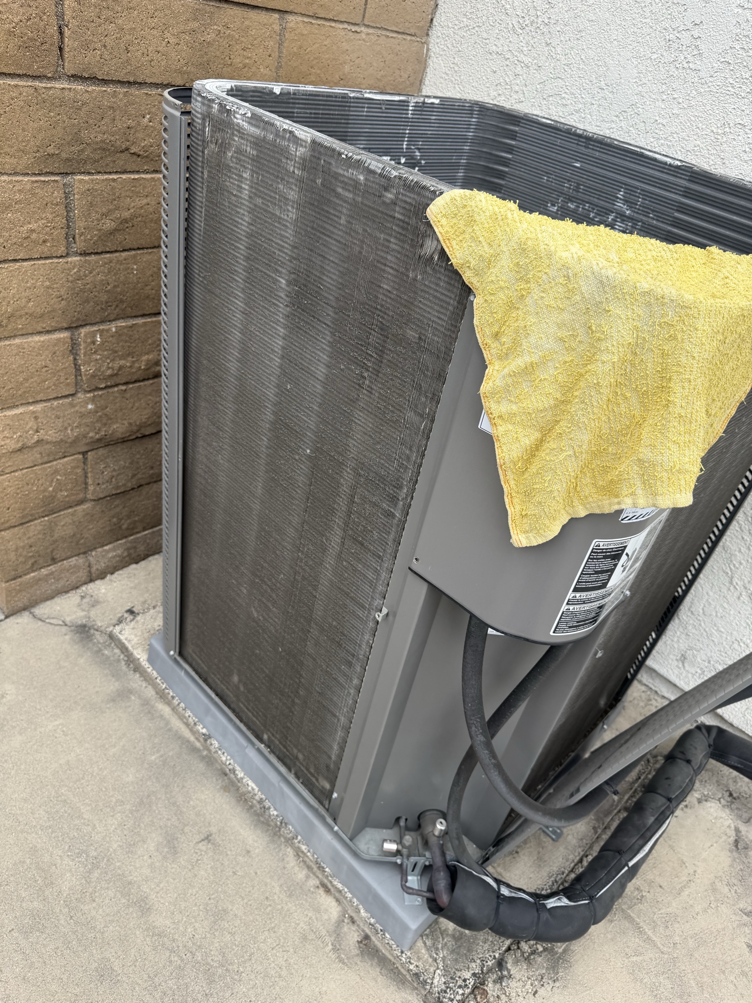 Condenser coil cleaning on outdoor AC unit