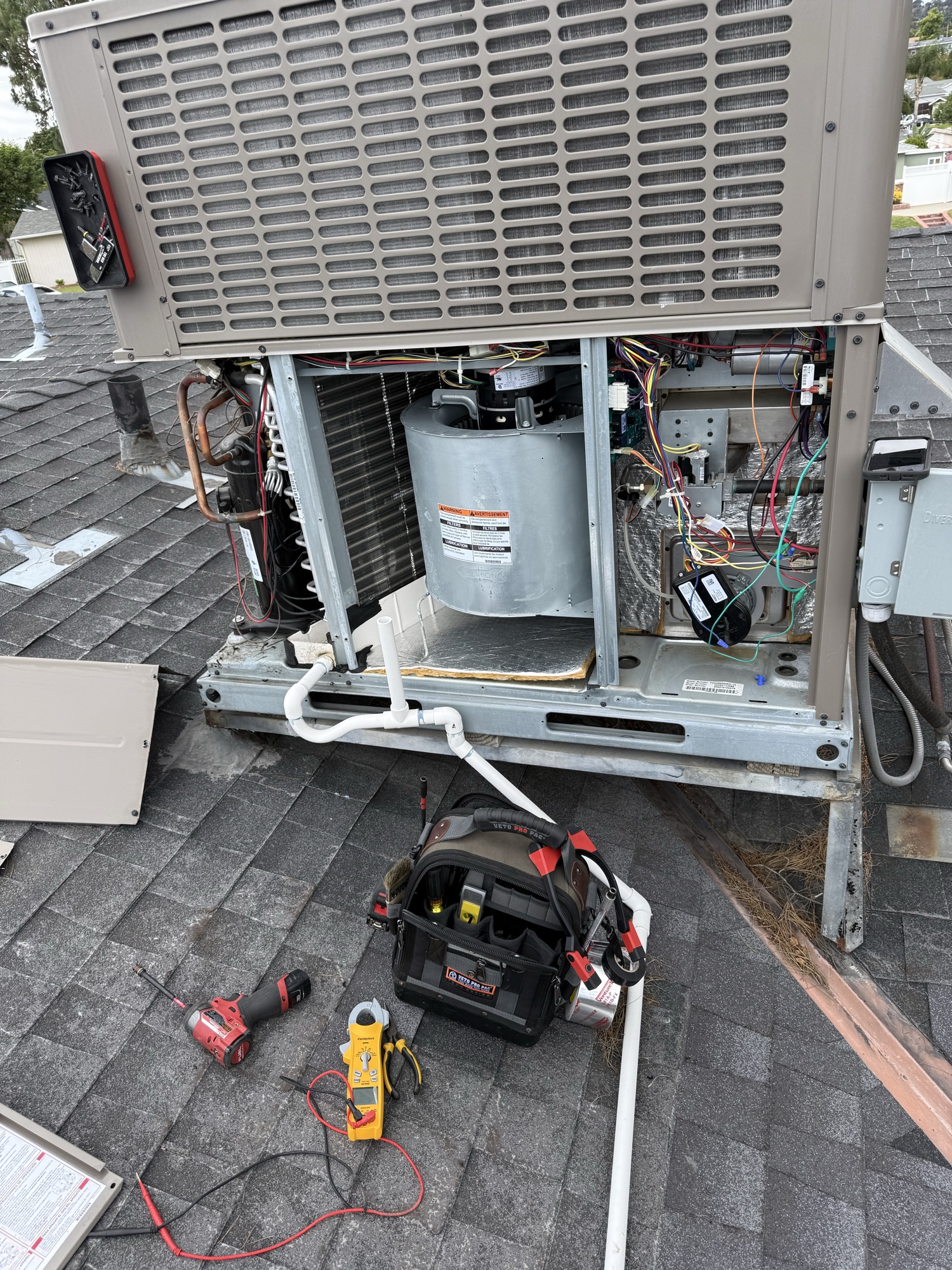 Rooftop RTU open for service with tools laid out